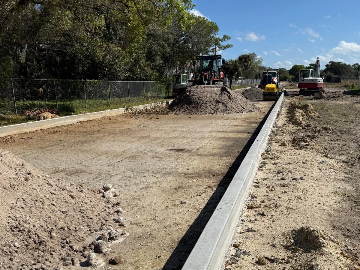 Curb, prepared subgrade, and construction equipment at the Alva School job site