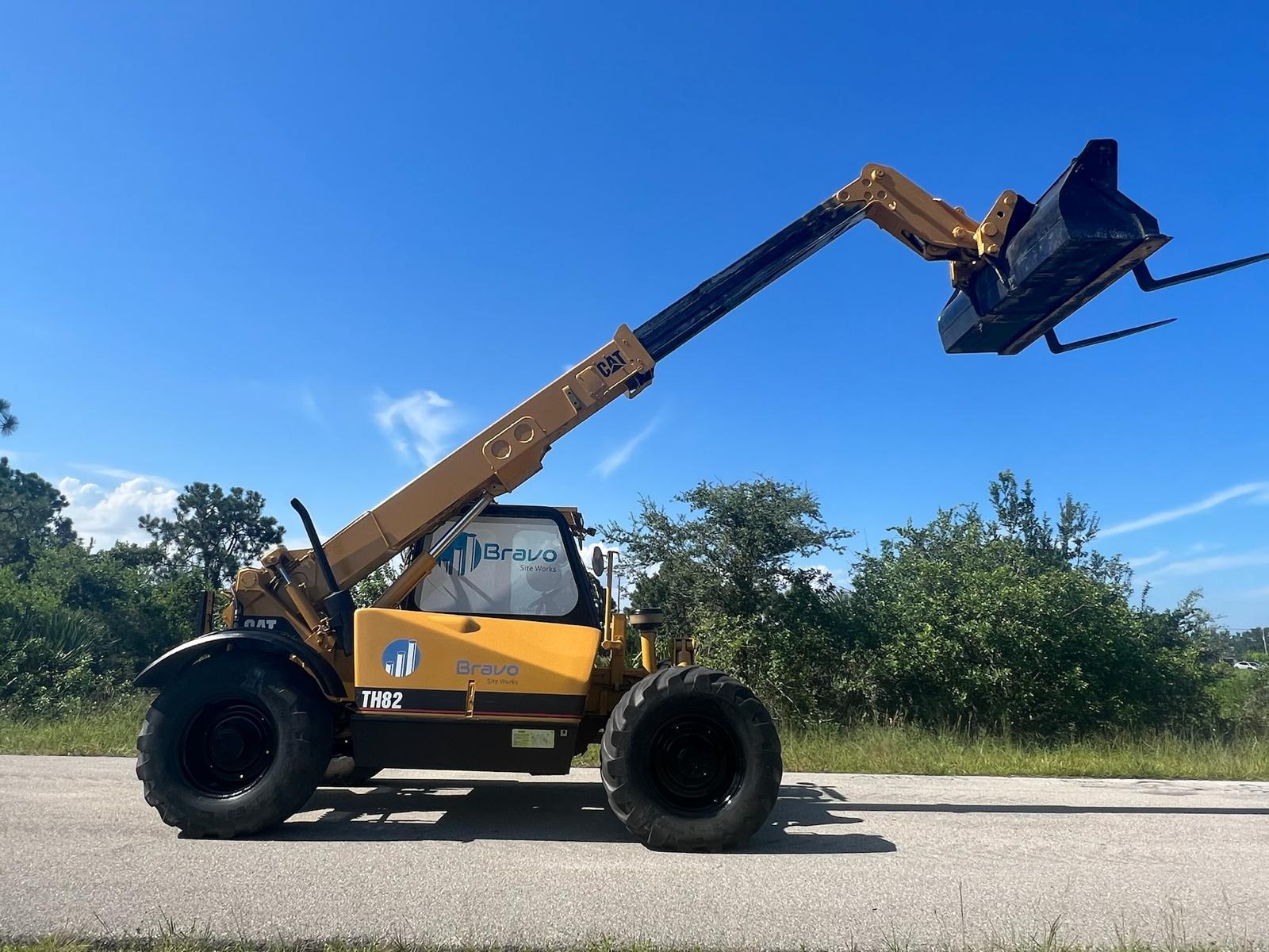 Bravo Site Works telehandler with its boom raised in Southwest Florida