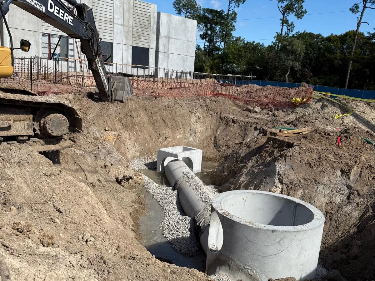 Concrete structures, pipe, and excavation equipment at the Collier County Behavioral Health job site