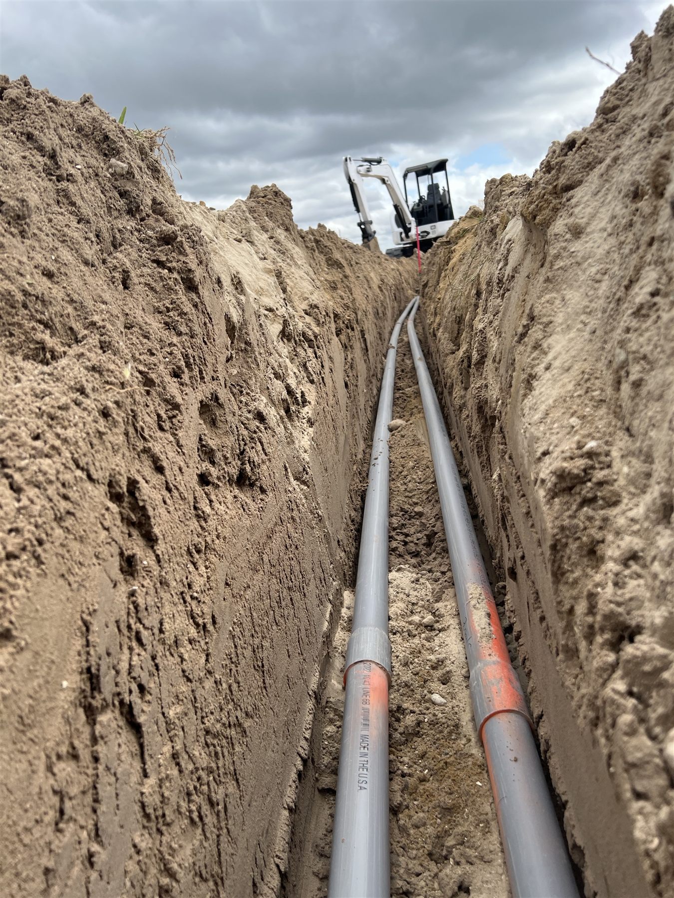 Prepared underground conduit alignment viewed from inside a trench