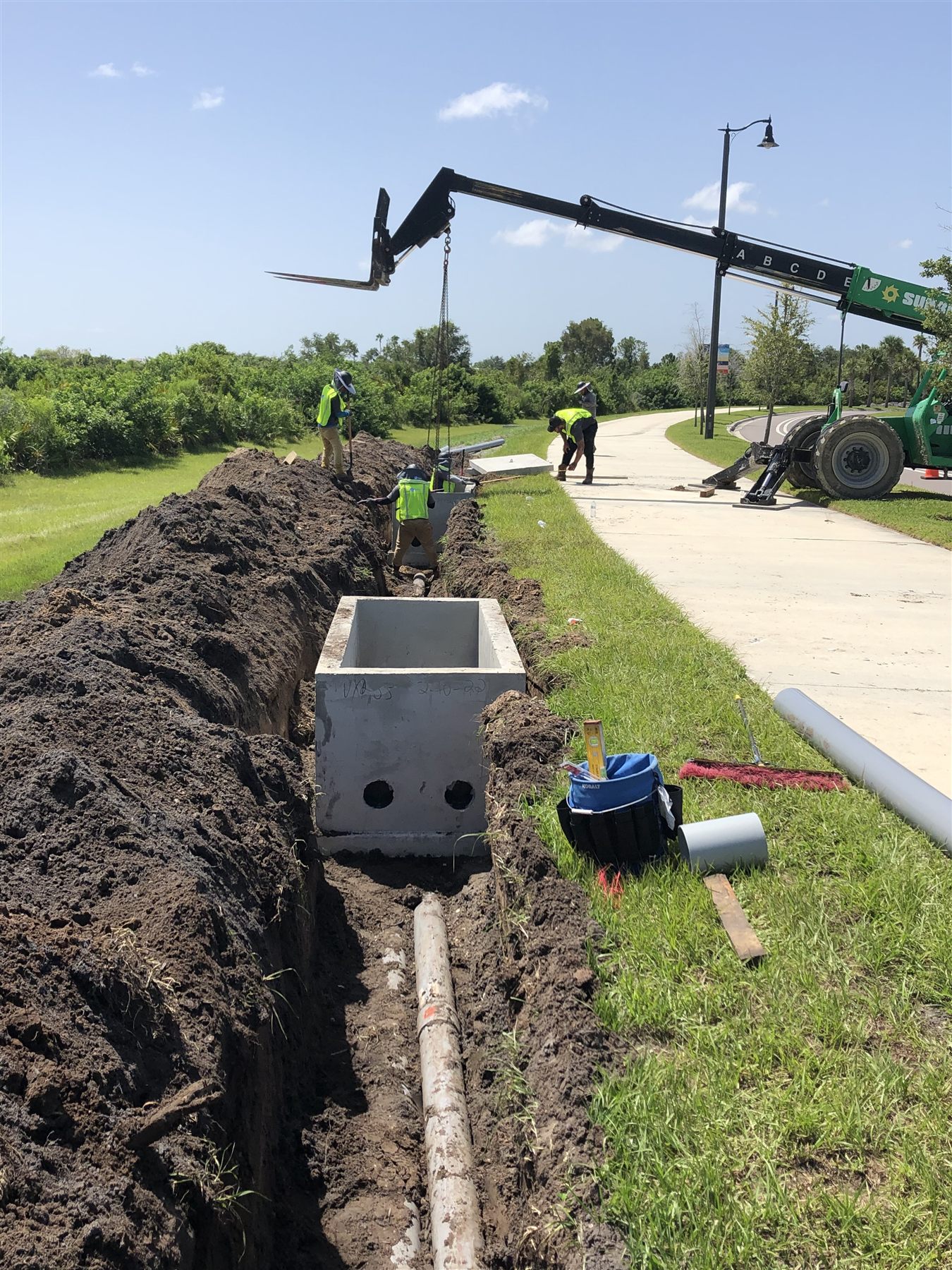 Underground utility structure installation beside a Southwest Florida roadway